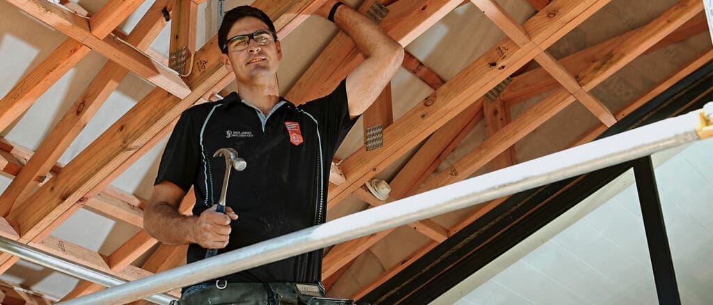 How To Choose The Right Builder 2 nzcb member builder working on roof trusses, giving a look of confidence in his work.