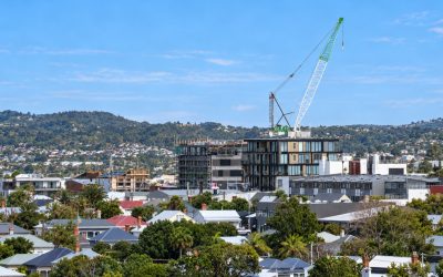 new zealand neighborhood with crane and hills
