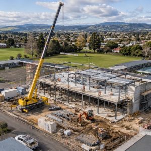 school construction beneath mountain skies