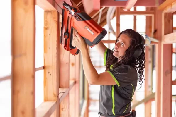 nzcb member using a paslode nailgun on job site