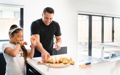 family having healthy breakfast at home with kids in auckland, new zealand.