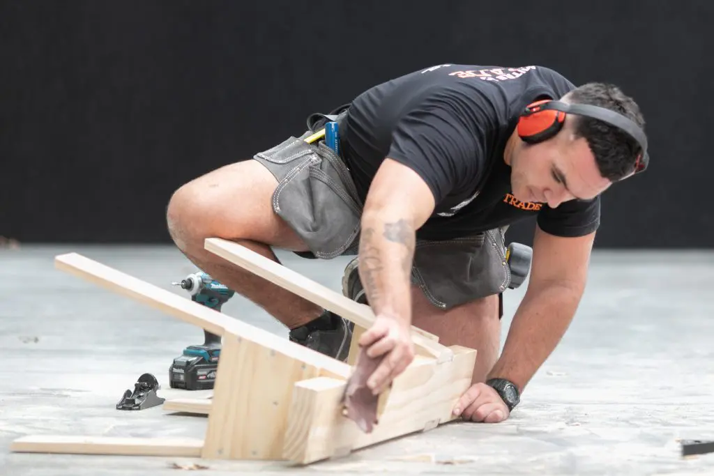 apprentice giving his saw horse finishing touches at the nzcb conference and expo