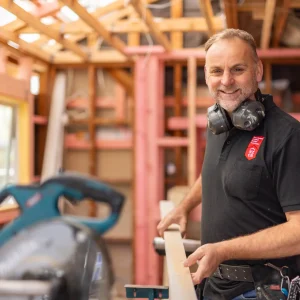 NZCB Member working on roof battens with mitre saw set up