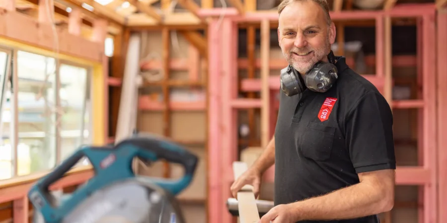 nzcb member working on roof battens with mitre saw set up
